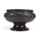 A Wedgwood black basalt bowl on stand, the body relief decorated with fruiting vines, d. 27 cm