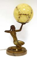 A figural table lamp in the Art Deco manner, modelled as a partially clad young lady, on a marble