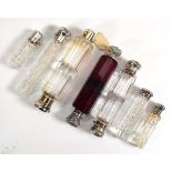 Eight 19th century and later silver mounted scent bottles, included a double ended cranberry glass