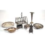 A group of silver comprising a six slice toast rack, two dishes, a tea strainer, a three piece cruet