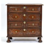 A 17th century and later oak chest of four drawers, each with geometric moulding, on later bun feet,