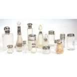 Sixteen 19th century and later silver mounted dressing table bottles, max h. 14 cm, various dates