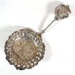 A Victorian silver straining spoon, repousse decorated with a classical scene, maker BHJ, London