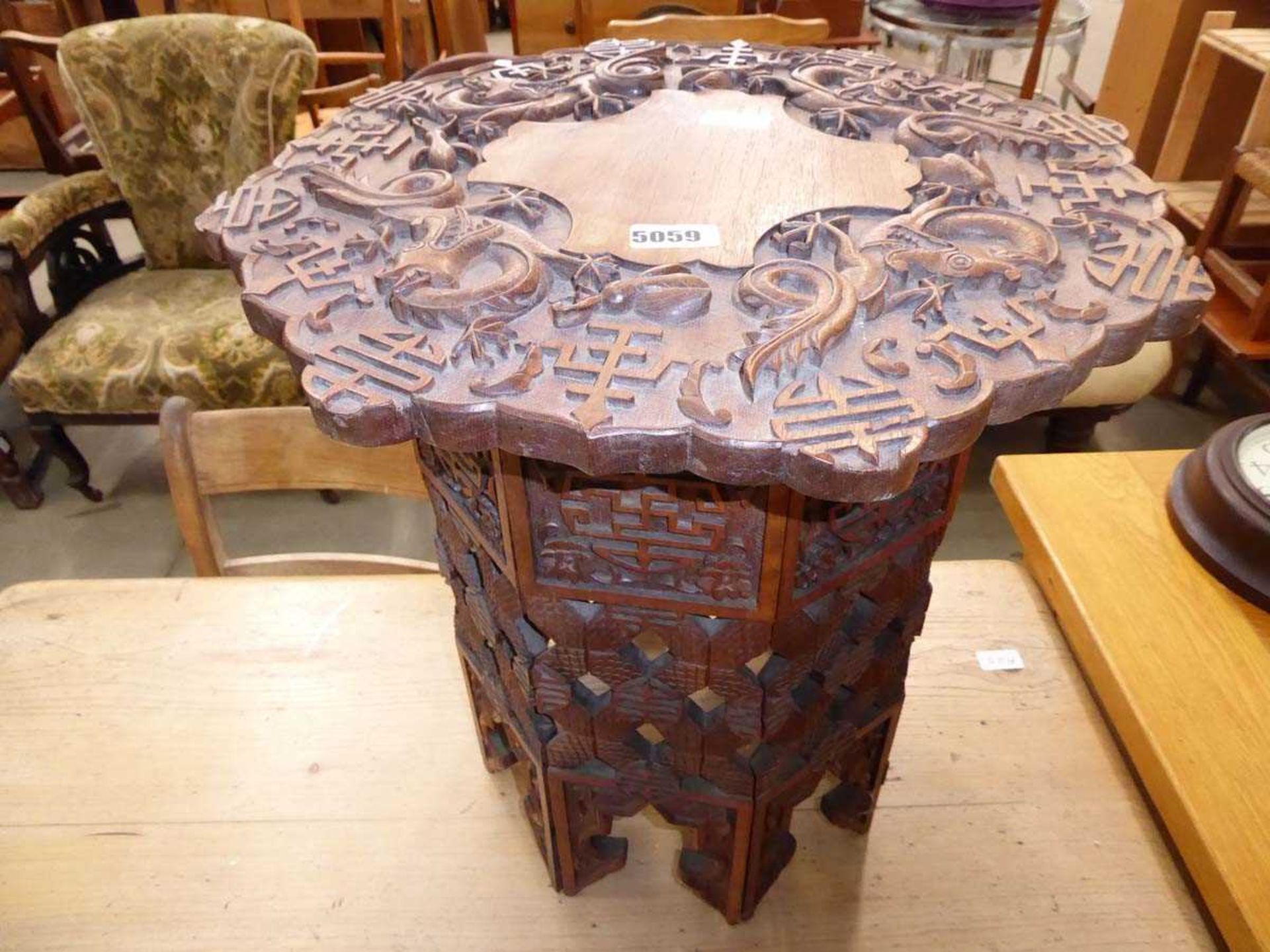 Heavily carved Chinese table with folding base