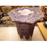 Heavily carved Chinese table with folding base