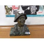 Metal figure of a boy's head and torso on marble plinth