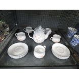 Cage containing a quantity of floral patterned Denby crockery