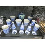 Cage containing a quantity of blue and white china to include shallow dishes, bells, coffee mugs,