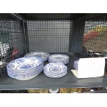 Cage containing a quantity of blue and white floral patterned ironstone crockery