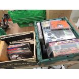 2 x boxes containing 7" vinyl records and video cassettes