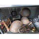 Cage containing military helmets, boot scraper, meat hook, brass bell, gunsmiths spares screws