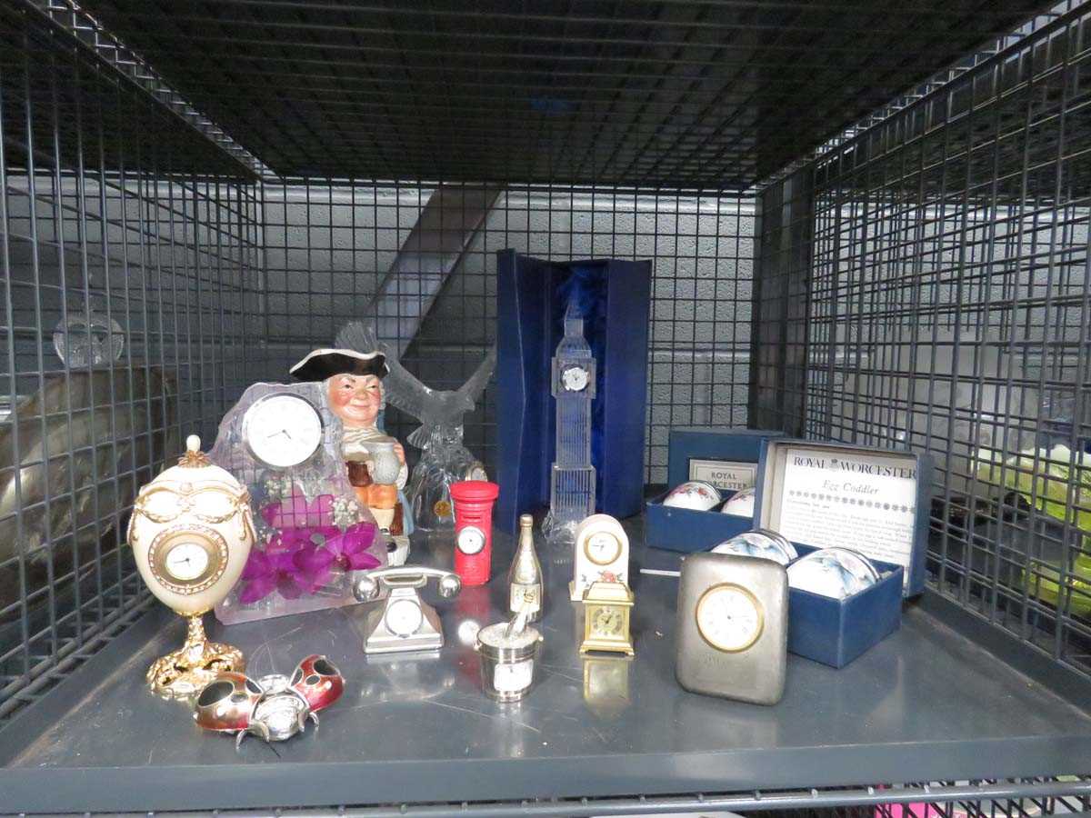 Cage containing a character jug, quartz clock, clocks in glass cases, miniature clocks and egg