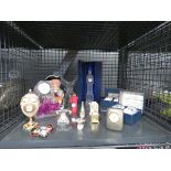 Cage containing a character jug, quartz clock, clocks in glass cases, miniature clocks and egg