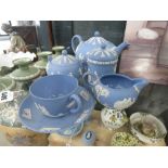 A Wedgwood Jasperware tea service in 'Wedgwood Blue' including a teapot, sugar bowl, jug, container,