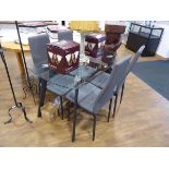 Modern glass 4 seater dining table with 4 matching grey upholstered high back dining chairs