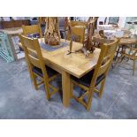 Modern light oak extending dining table with 4 matching oak black upholstered dining chairs