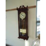 Mahogany cased wall clock with 2 weights, pendulum and key