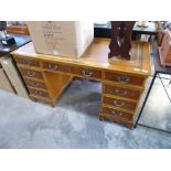 Yew twin pedestal office desk with tooled leather writing surface