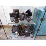 2 shelves of vintage camera equipment