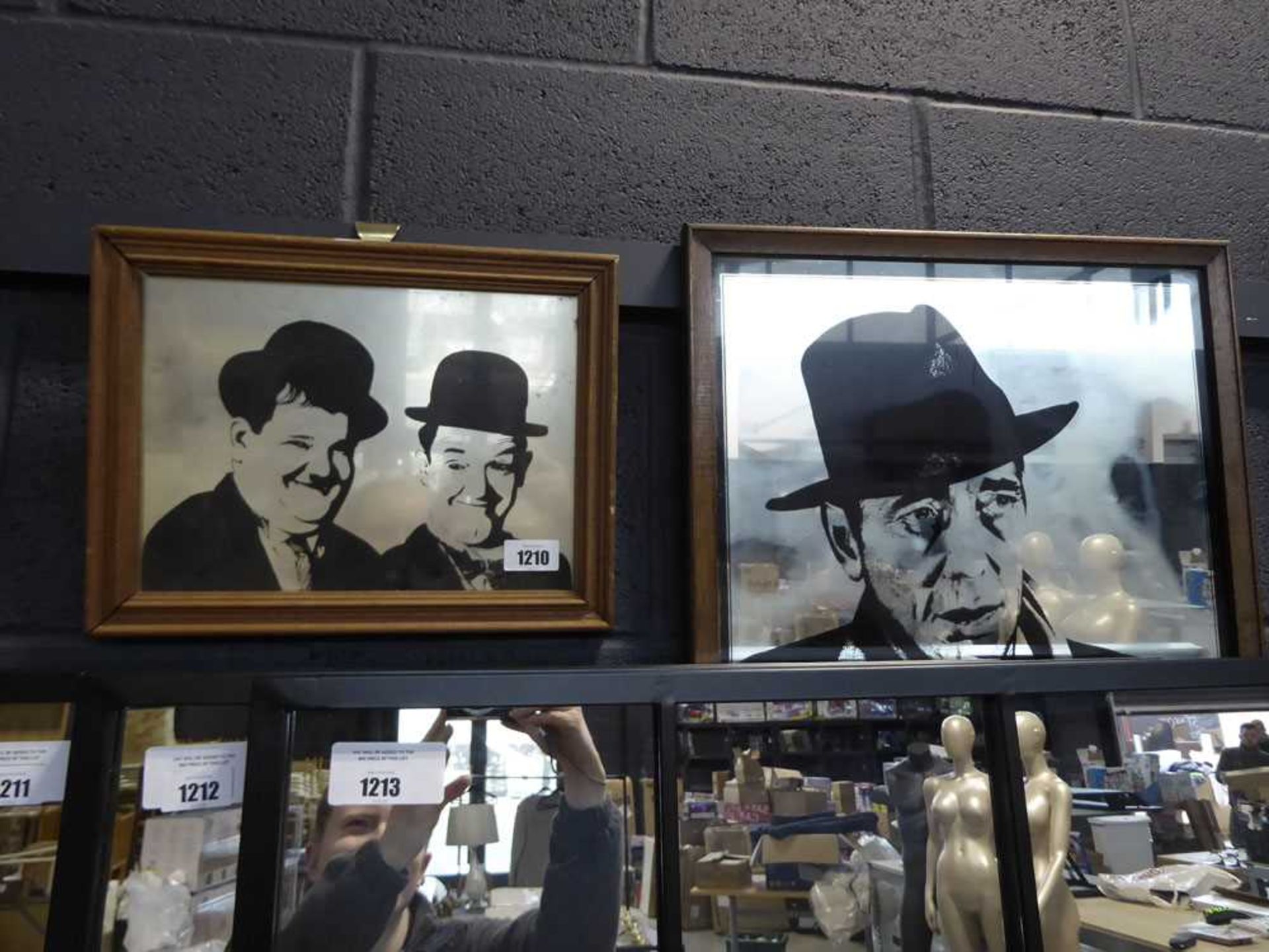 2 framed mirrors - 1 depicting Laurel and Hardy and 1 depicting Jazz musician