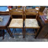 A pair of wooden rush seated stools