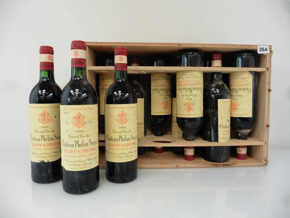 A case of 12 bottles of Chateau Phelan Segur 1982 Saint-Estephe, France in own wooden box (ullages