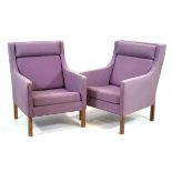 A pair of 1970's Danish Model 2431 lounge armchairs upholstered in purple fabric on square legs