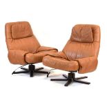 A pair of Swedish 1970's tan leather reclining armchairs on laminate five-star swivel bases*Sold