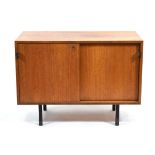 A 1970's teak cabinet, the two sliding doors with leather handles, on black metal legs, w. 91 cm