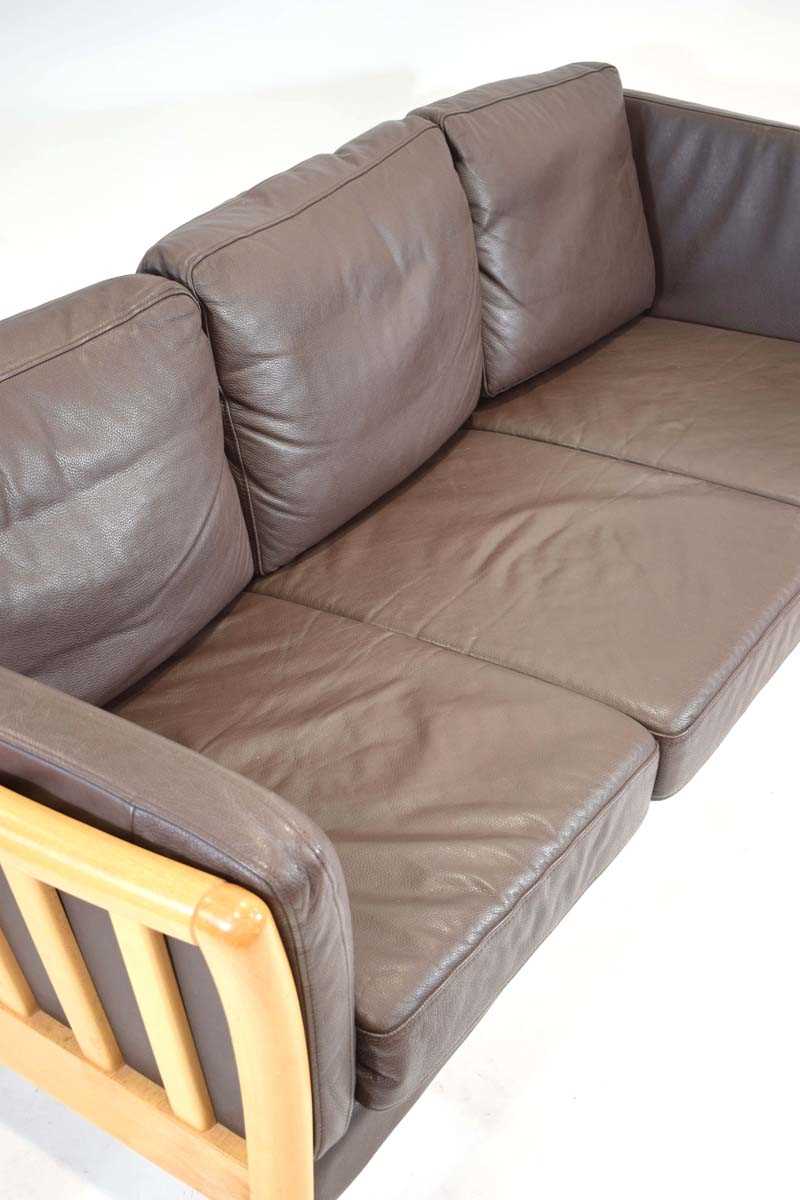 A Danish beech framed three-seater sofa with brown leather upholstery*Sold subject to our Soft - Image 2 of 3