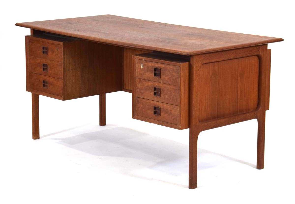 A 1960's Danish teak and crossbanded desk designed by Arne Vodder (1926-2009), the two 'floating'