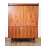 A 1980's Danish simulated rosewood office cabinet with four doors, on associated tapering legs, w.