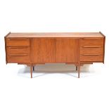 A 1960's Danish teak sideboard, the pair of central doors flanked by two sets of three drawers, on