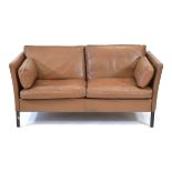 A 1970's Danish two-seater sofa by Georg Thams, upholstered in brown leather on square legs*Sold