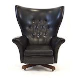 A 1960's G-Plan '62' armchair, the black button upholstered seat on a teak four-star base*Sold