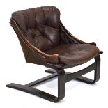 A 1970's Norwegian lounge chair, the brown leather button-upholstered seat on a bentwood frame*