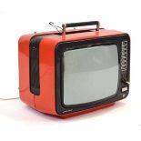 A vintage Grundig Super Color 1510 television in a red caseLead cut and working order unknown.
