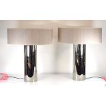 A pair of French contemporary table lamps with chromed cylindrical bodies, h. 45 cm excl. fittings