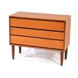 A 1970's teak three-drawer chest on later tapering legs, w. 79 cm
