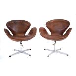 Arne Jacobsen (1902-1971) for Fritz Hansen, a pair of 'Swan' chairs upholstered in brown leather