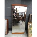 A 1960/70's English wall mirror with teak mounts, 79 x 36 cm