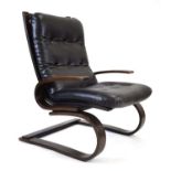 A 1960's bent ply lounge armchair of Danish design with black button upholstery *Sold subject to our