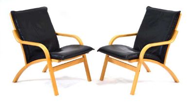 A pair of 1960's Danish armchairs by Mogens Hansen, the beech frames supporting loose black