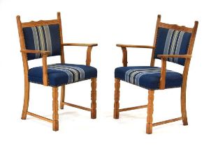 A pair of 1960/70's Swedish oak armchairs or carvers by Henning Kjaernulf with blue fabric studded