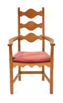 A 1960/70's Swedish oak ladderback armchair or carver by Henning Kjaernulf with a pink fabric drop