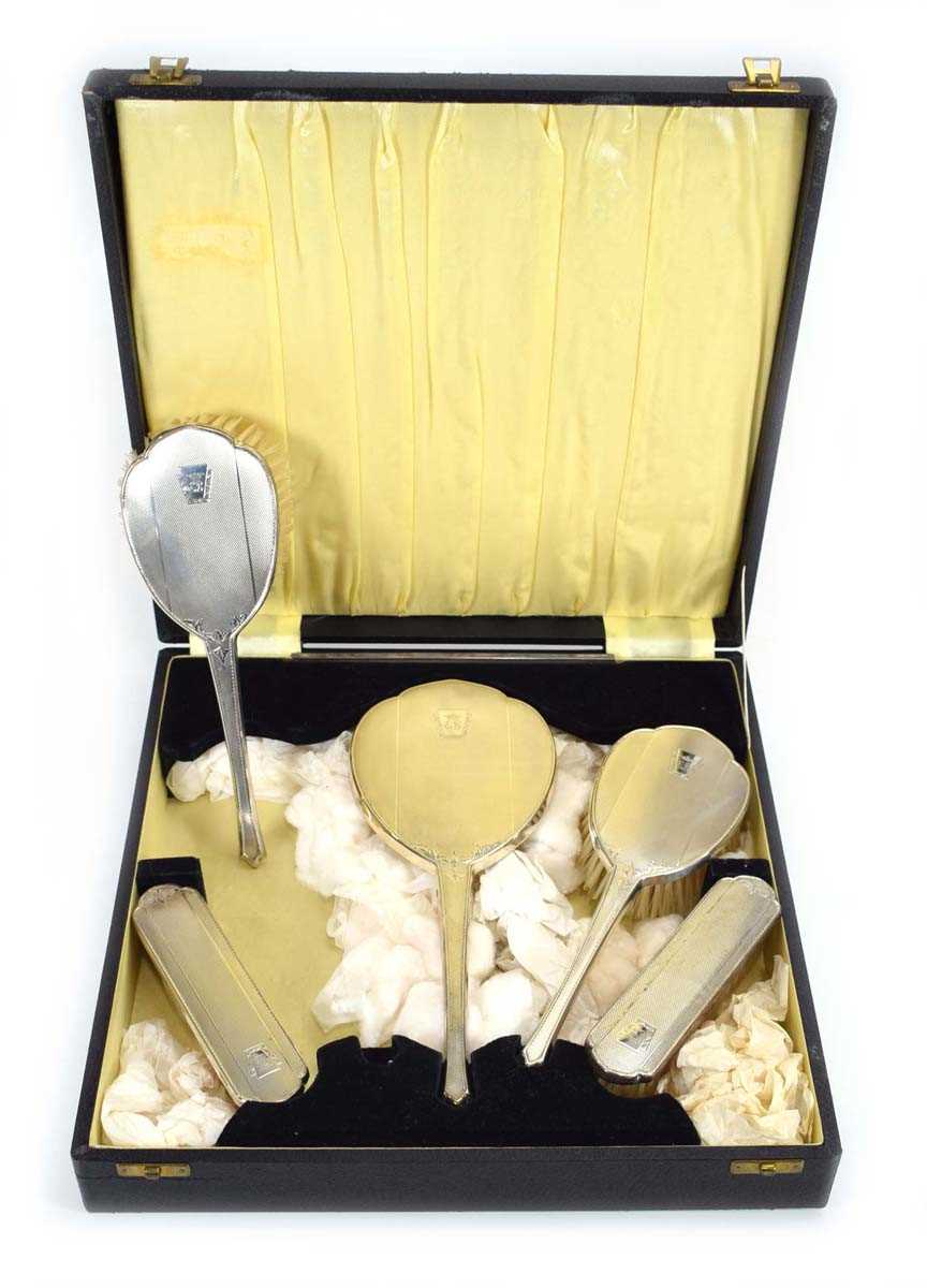 A mid 20th century silver five piece engine turned dressing table set, maker DM Co., Birmingham