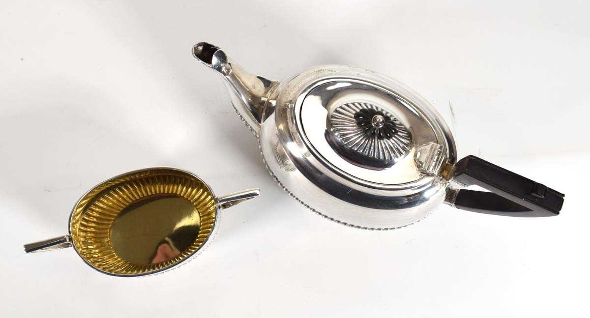 An early 20th century silver bachelors' teapot with gadrooned decoration and a matching two - Image 2 of 2