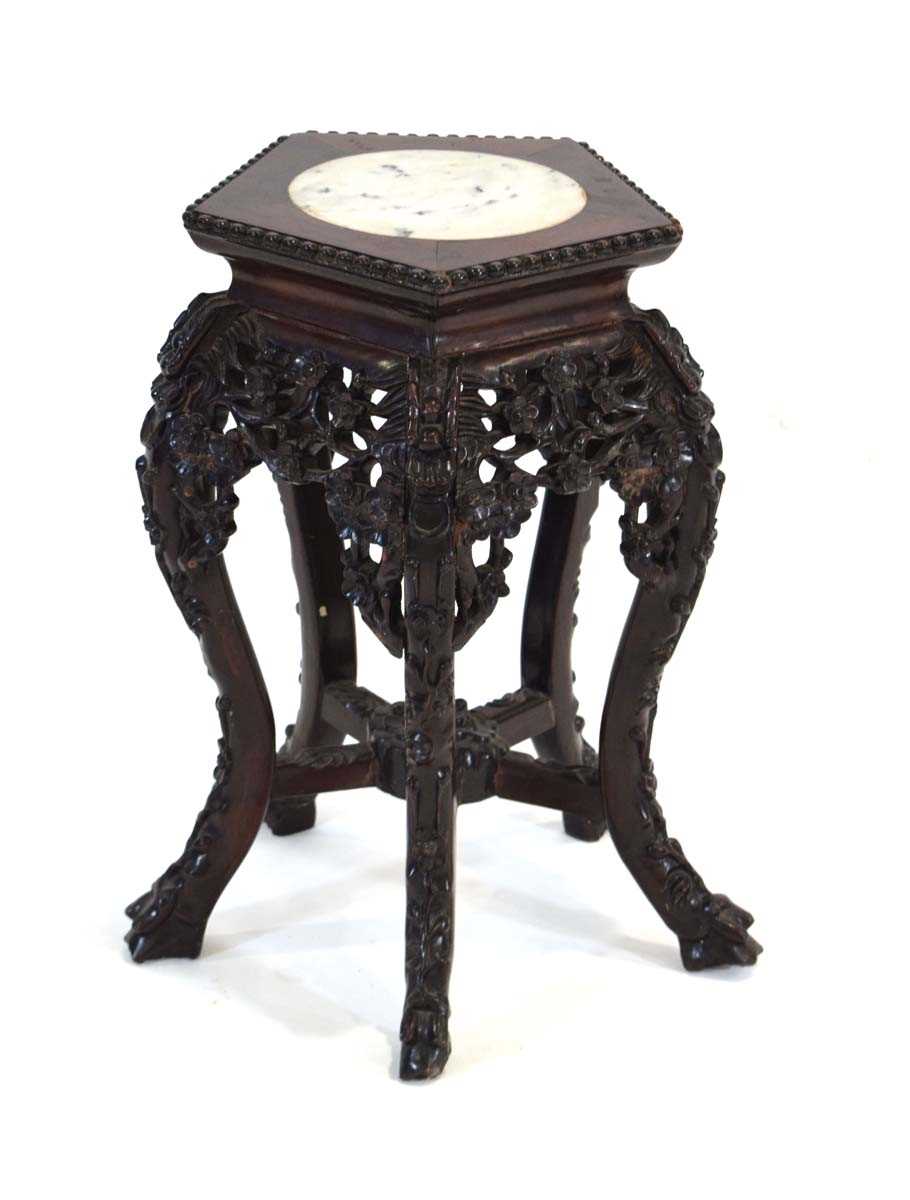 A 20th Century Chinese Export plant stand, the marble surface inset in a rosewood surround with
