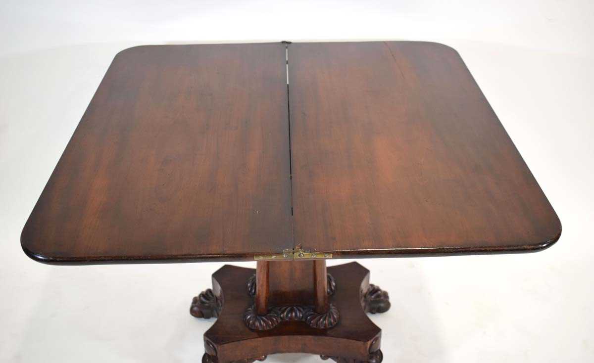 A 19th century mahogany fold-over tea table on a shaped column, platform base and claw feet, w. 91 - Image 4 of 4