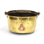 A 19th century brass and copper mounted preserving pot with a swing handle, d. 44 cm